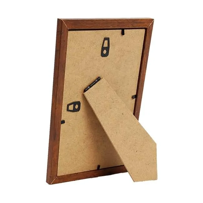 Backside view of a wooden photo frame with a stand for tabletop display and hooks for wall mounting.