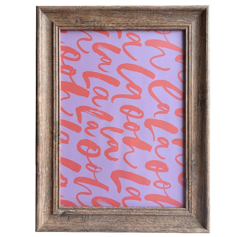 Rustic wooden photo frame with a vibrant purple background featuring red calligraphy text pattern.