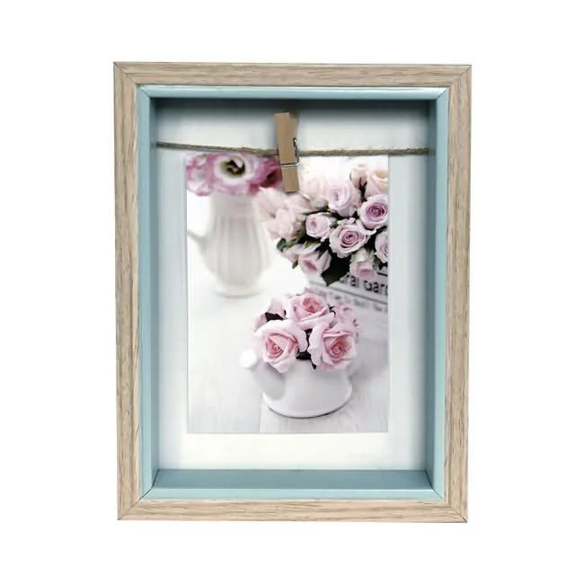 Light wood photo frame with inner blue edge, showcasing a floral image held by a twine and small clip.