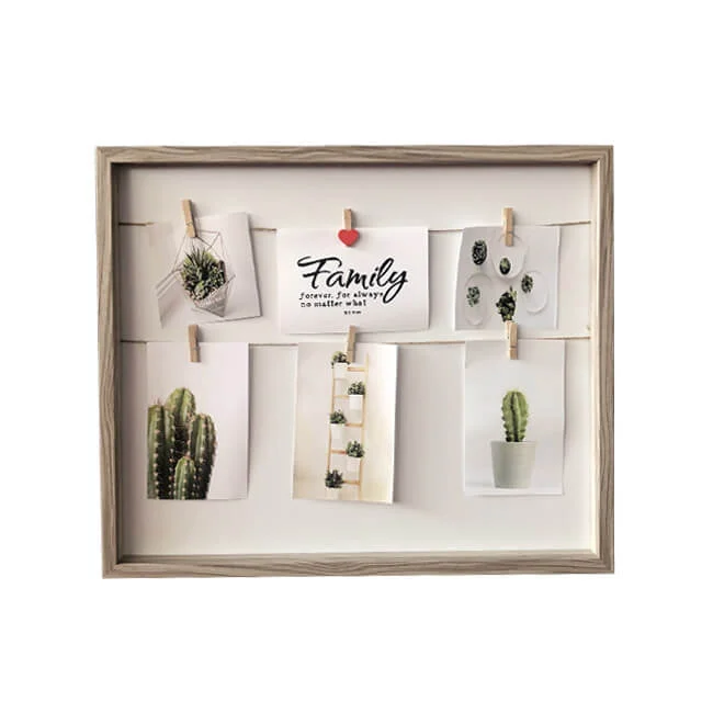 A rustic wooden photo frame holding a collage of photos featuring succulent plants and a family-themed quote, secured with mini clothespins.