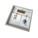 Square wooden photo frame with decorative design featuring 'Home' sign and two hanging cards with text and a botanical illustration.