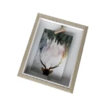 A wooden photo frame with a slightly rustic light wood finish, showcasing an artistic image of a deer with antlers and a forest background held by a small clip.