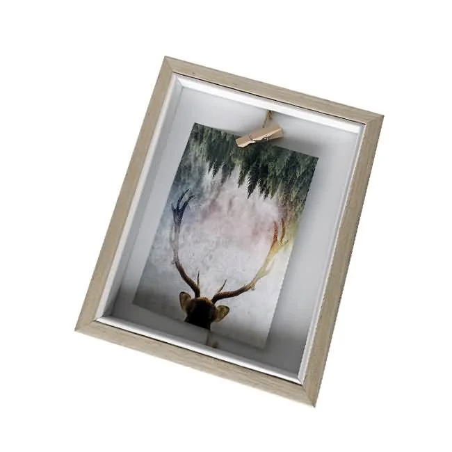 A wooden photo frame with a slightly rustic light wood finish, showcasing an artistic image of a deer with antlers and a forest background held by a small clip.