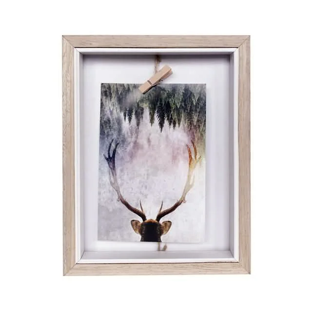 Wooden rectangular photo frame featuring a deer image with antlers, suspended by a clip against a forest-themed background.
