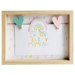 A light wooden photo frame featuring a colorful message 'Enjoy Every Moment' with pastel decorations and a rainbow motif.