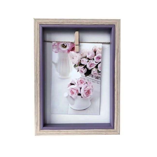 Wooden photo frame with a soft lavender inner border showcasing a floral image clipped on a string.