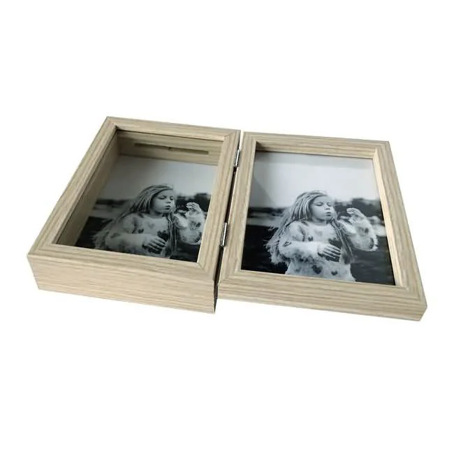 Dual wooden photo frame with hinged opening, holding black-and-white photos of a girl, placed on a white background.