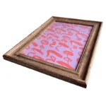 A rustic wooden photo frame displaying a pink pattern with red abstract text on it, angled for a modern presentation.