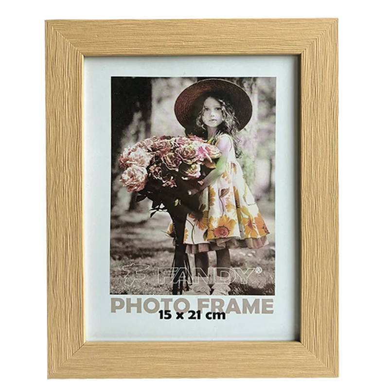 A decorative wooden photo frame with a 15x21 cm photo of a young girl in a floral dress holding a bouquet of flowers.
