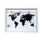 A white photo display frame featuring a black world map design on a white grid background with wooden clips on a string for hanging photos.