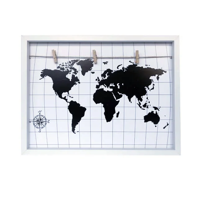 A white photo display frame featuring a black world map design on a white grid background with wooden clips on a string for hanging photos.