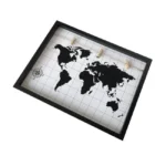 Wall-mounted photo display frame with black border, world map design on a white grid background, and four wooden clips.