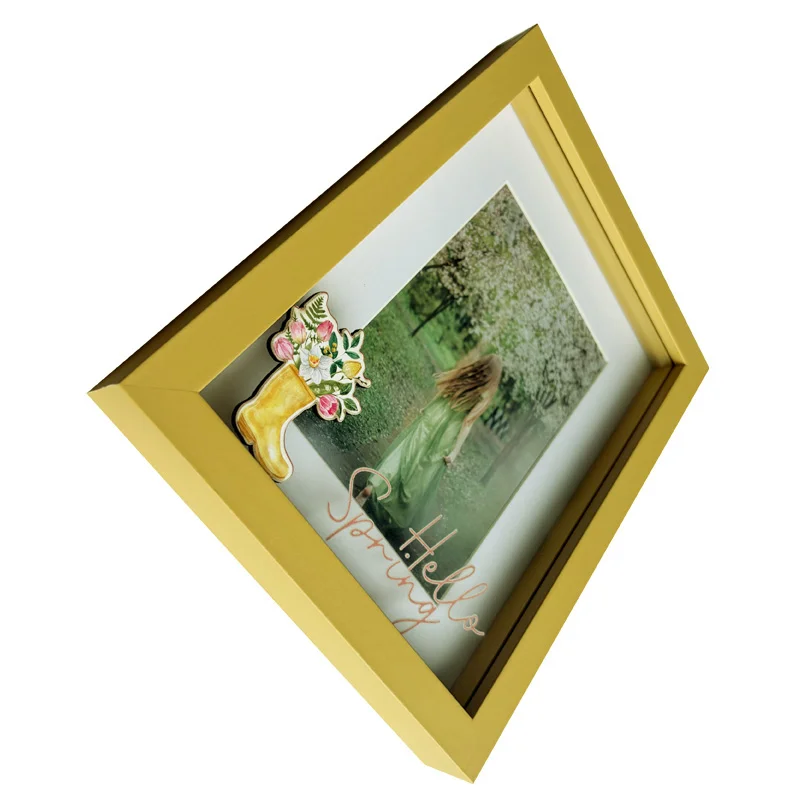 A sleek yellow photo frame featuring a spring-themed illustration, including a floral bouquet in a boot and 'Hello Spring' text.