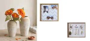 Decorative beige vases with orange flowers on a table next to wooden collage photo frames displaying pictures and art.